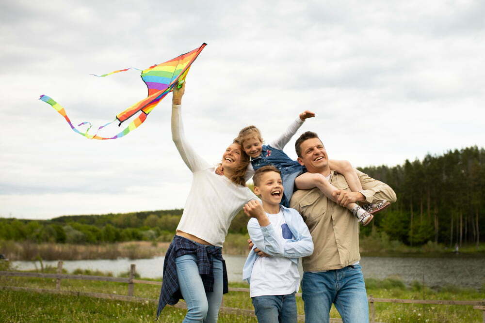 medium shot family with colorful kite